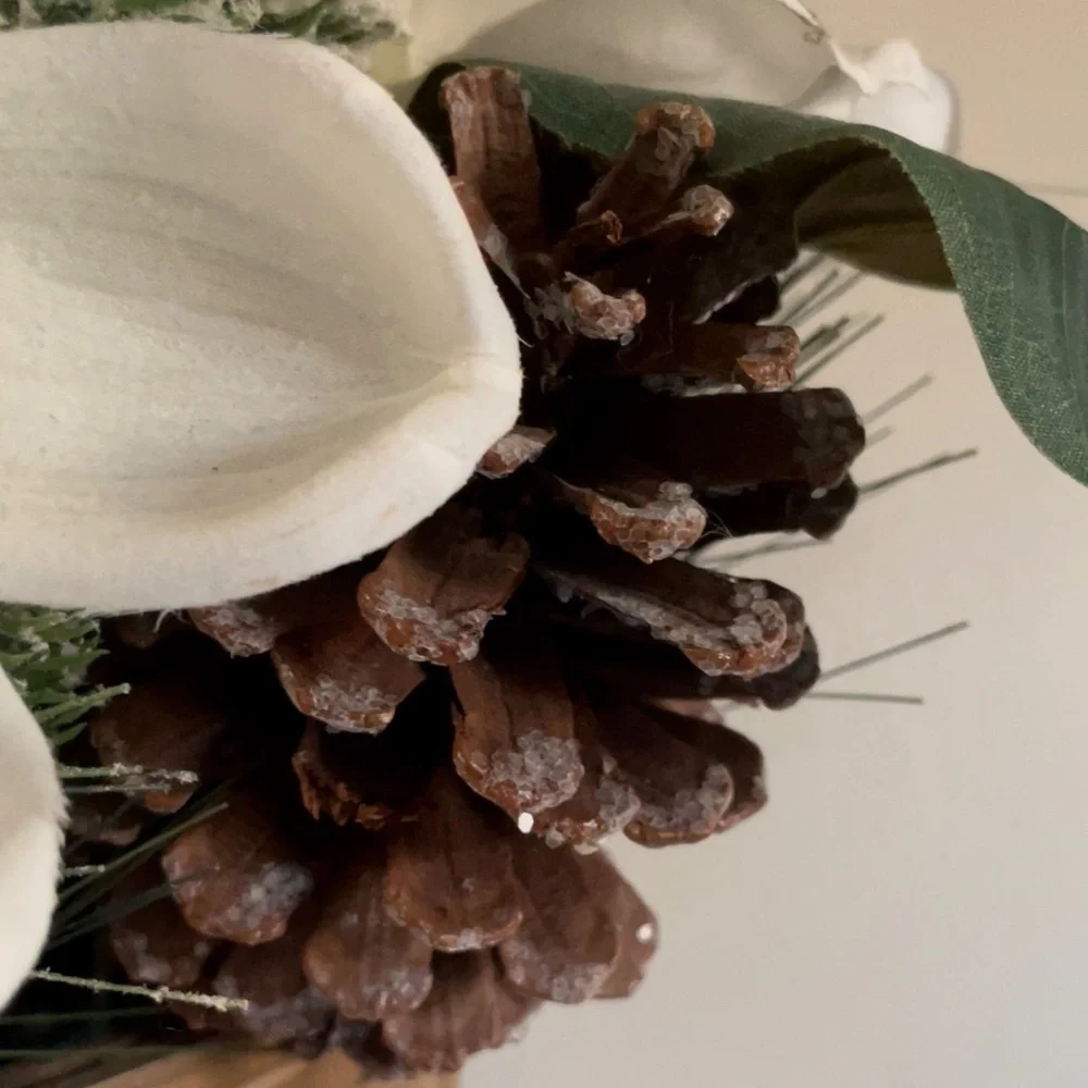 Winter hanging basket floral decor pinecones white flowers pine needles wreath